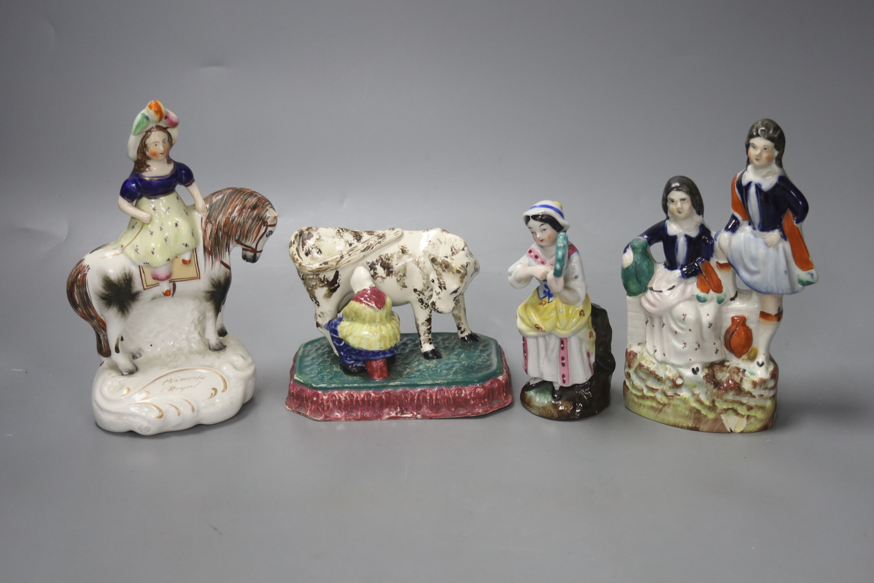 A North Country pearlware milkmaid group, c.1820, two Staffordshire figure groups and a Continental figurine, tallest 18cm